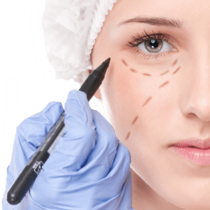 A female patient having marks drawn on their face by a plastic surgeon