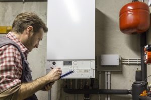 A man checking on a boiler.
