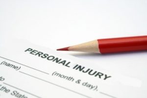 A red pencil on top of a personal injury form. 