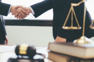 A personal injury solicitor shaking hands with a client. 