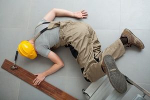 Injured worker lying on the floor after an accident