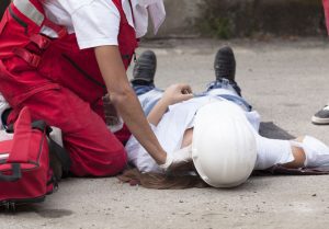 A woman lying on the floor after a lifting injury. 