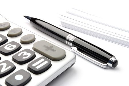 A black pen laying next to a calculator.