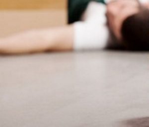 A blurry image of an injured worked lying on the ground