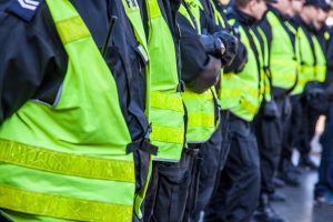 A group of police officers wearing hi-vis lined up side by side