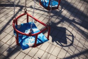 Carousel seats on a swing at a public park for which the local council are responsible for maintaining. 