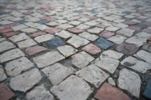 A closeup view of a pavement with cobblestone tiles to represent our guide on pavement accident claims
