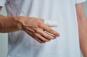 A person with a bandaged thumb.