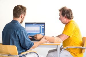 A man discussing prosthetics with a health worker after loss of a limb