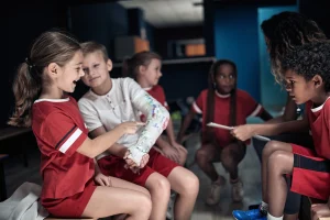 A child with a cast on his arm with other children injured on a school trip.