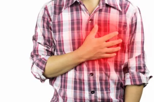 A man holding his chest after sustaining an injury to his ribs