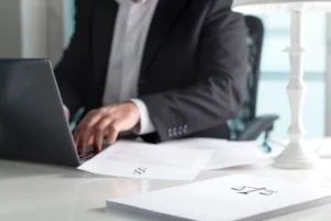 A solicitor working on their client's claim for a car accident without a seatbelt at their desk